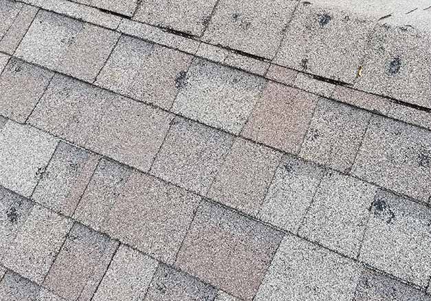Midwest hail damage storm damaged ridge line - John Beal Roofing crew documentation